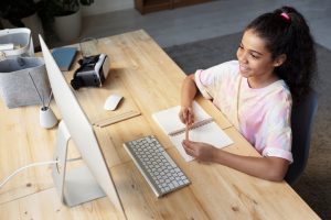Canva-Girl-in-Pink-T-shirt-Looking-at-the-Imac-1024x683-1.jpg